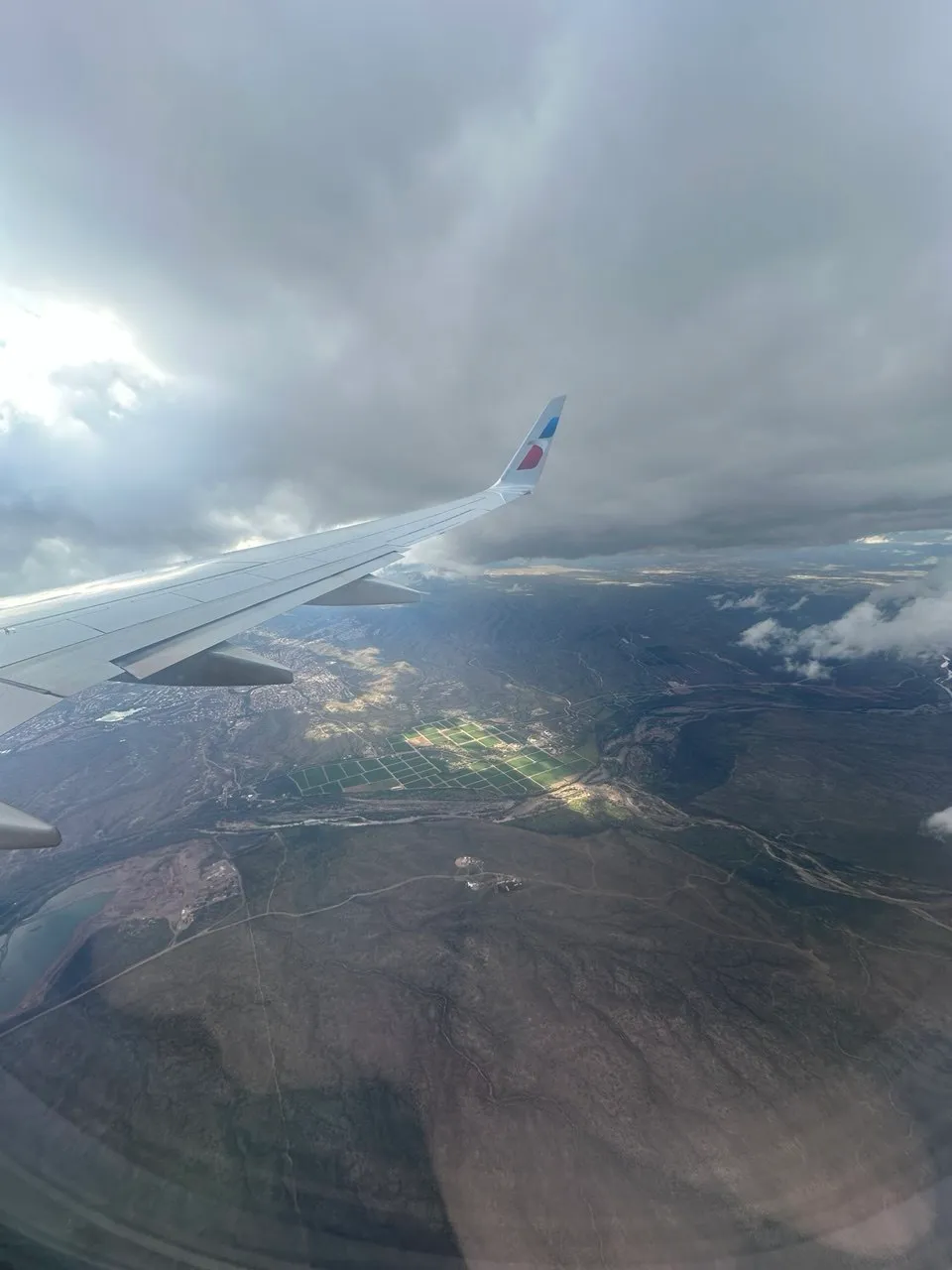 Airplane wing over Arizona mountains